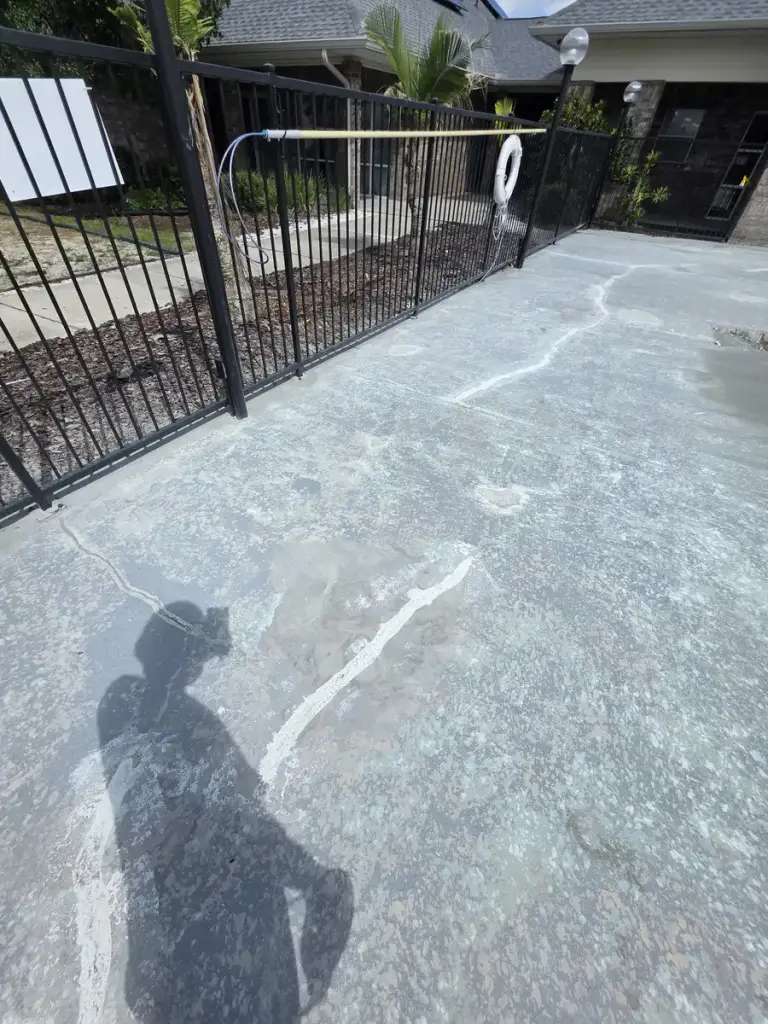 Prepared repair line across a concrete pool-deck surface during restoration work.